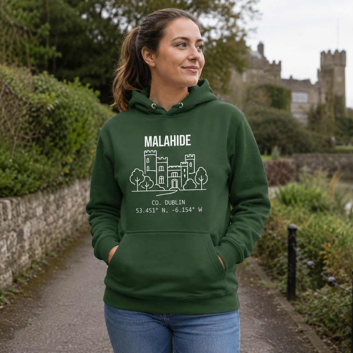 Woman wearing the Dublin Malahide forest green hoodie near Malahide Castle
