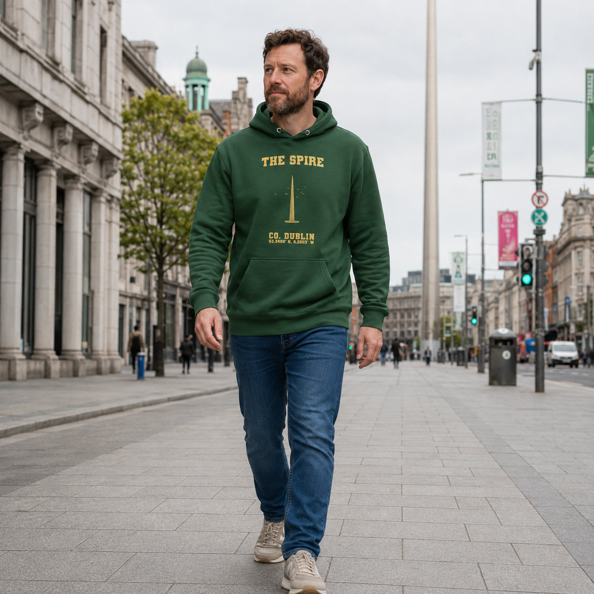 Man wearing the Dublin Spire forest green hoodie on O'Connell Street