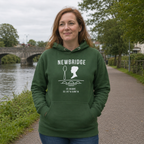 Woman wearing the Kildare Newbridge forest green hoodie beside the River Liffey